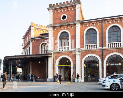 BRESCIA, ITALY - FEBRUARY 21, 2019: passengers near raiway station in Brescia city in evening. Brescia is the second largest city in Lombardy Stock Photo