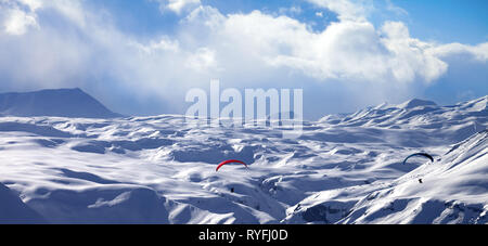 Panoramic view on speed flying in snowy winter mountains. Caucasus Mountains. Georgia, region Gudauri. Stock Photo