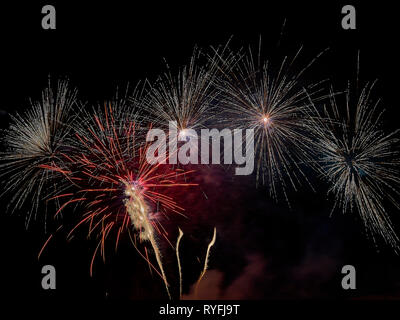 Colorful fireworks against a dark night sky Stock Photo