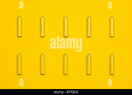 Top view yellow AAA alkaline batteries colorful pop art style flat lay photo pattern Stock Photo
