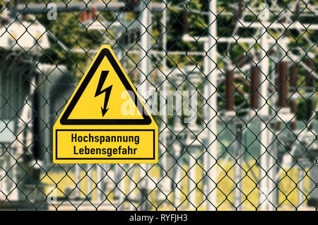 Electrical hazard sign placed on a fence of an electrical substation Stock Photo