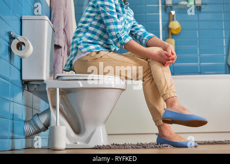 partial view of girl in white underwear holding toilet paper while  suffering from diarrhea Stock Photo by LightFieldStudios