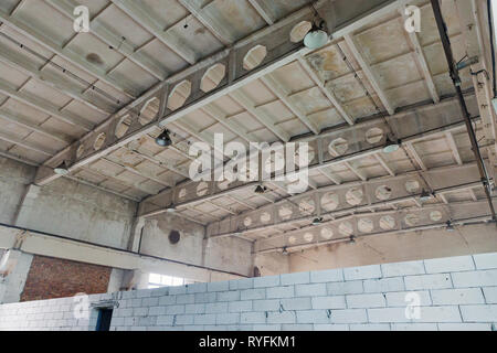 abandoned old factory building inside, ceiling construction elements Stock Photo