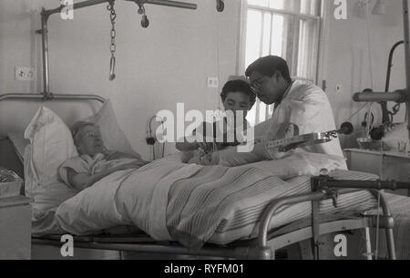 1950s DOCTOR NURSE PATIENT BED HOSPITAL SICK ILLNESS Stock Photo - Alamy