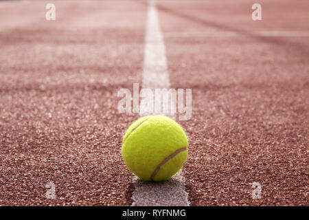 Tennis ball yellow on hard court white line close up Stock Photo