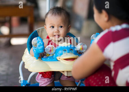 Asian vietnamese baby smiling in his little baby chair, SaPa, Vietnam Stock Photo