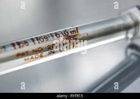 Vintage glass syringe 'made in USA', isolated on white background, close-up Stock Photo