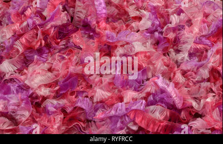 Close up of strands of fluffy pink and purple yarn or ribbo Stock Photo