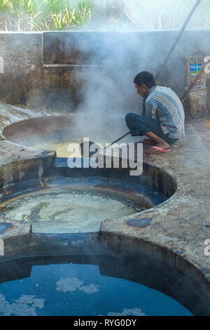 HIMACHAL PRADESH, INDIA. The juice of the sugar cane plant is transfomed to crystalline cane sugar by boiling Stock Photo