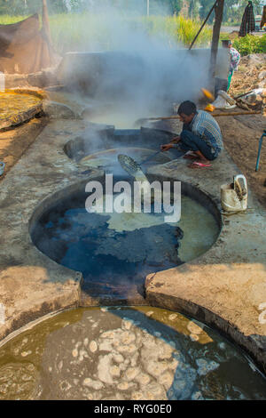 HIMACHAL PRADESH, INDIA. 10-29-2015. The juice of the sugar cane plant is transfomed to crystalline cane sugar by boiling Stock Photo