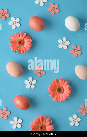Coral gerbera daisy flowers and craft papper shopping bags on green paper background, Springtime sale concept image with copy-space Stock Photo