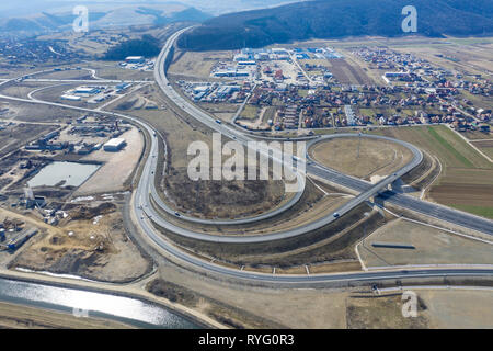 Flying above cars and trucks on a bustling highway, aerial drone shot Stock Photo