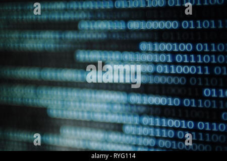 digital data transfer. one and zero binary data matrix flowing side way. binary code with bokeh defocus out of focus light. Stock Photo