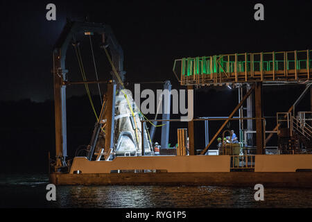 The SpaceX Dragon commercial crew capsule arrives in port aboard the recovery ship, Go Searcher, after returning from the maiden flight to the International Space Station March 9, 2019 in Port Canaveral, Florida. Stock Photo