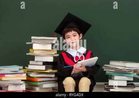 Primary school boy in bachelor's coats Stock Photo