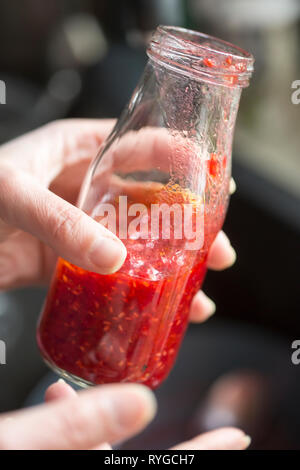 Preparing raspberry vinaigrette dressing Stock Photo