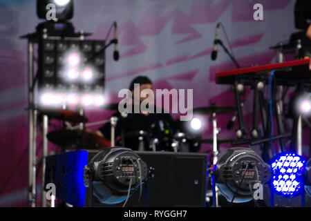 Drummer playing the drums with smoke and powder in the background Stock Photo