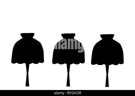 White brick wall and three black, various forms of lamps hanging from the ceiling Stock Photo