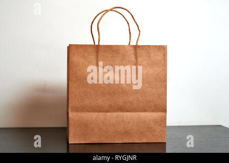 Luxury paper shopping bag on black dresser Stock Photo