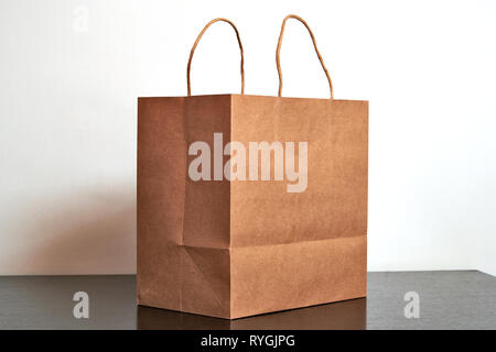 Luxury paper shopping bag on black dresser Stock Photo
