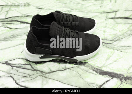 Single new unbranded black sport running shoe, sneakers or trainers isolated on white background with clipping path Stock Photo
