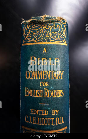 Close up of the book spine on an Antique Book of Bible Commentary for English readers book by C.J. Elliott Stock Photo