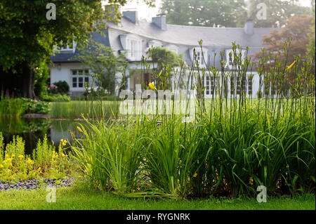 Pond by colonial house Stock Photo