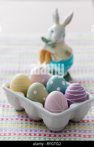Dyed Easter eggs with toy rabbit Stock Photo