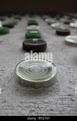 Wall design of colored glass wine bottles stuck in the concrete wall. Stock Photo
