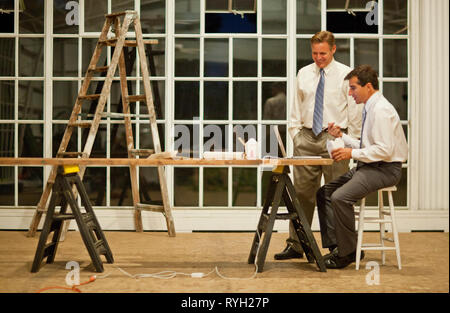 Two businessmen eating Chinese food while working late on a project. Stock Photo