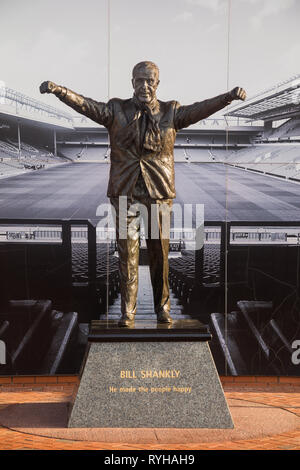 Bronze statue of triumphant Bill Shankly legendary Scottish ex-manager of Liverpool Football Club by Tom Murphy outside The Kop stand, Anfield Stadium Stock Photo