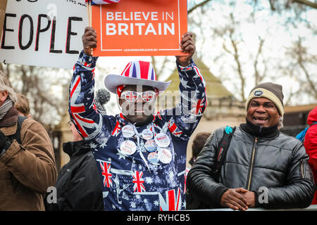 Westminster, London, UK. 13th Mar, 2019.  Leave Means Leave activist and protester Joseph Afrane in colourful Union Jack outfit. Pro- and Anti-Brexit protesters rally outside the Houses of Parliament on the day of another vote by MP's on Brexit. Credit: Imageplotter/Alamy Live News Stock Photo