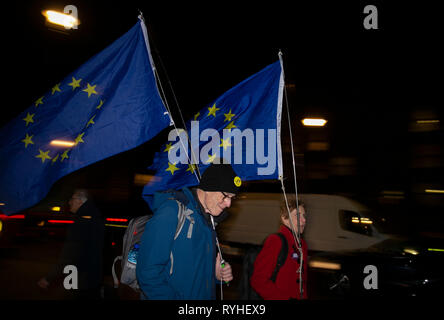 London, UK. 13th Mar, 2019. Demonstrators pass by the Houses of Parliament in London, Britain on March 13, 2019. No-deal Brexit was completely ruled out on Wednesday night by the British parliament in a vote which led to a second government defeat in less than one hour. Credit: Han Yan/Xinhua/Alamy Live News Stock Photo