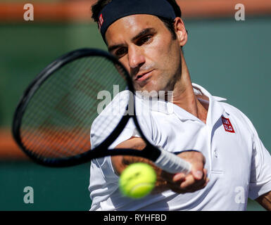 Indian Wells, USA. 13th Mar, 2019. Roger Federer of Switzerland returns the ball to Kyle Edmund of Britain during the men's singles fourth round match of the BNP Paribas Open tennis tournament in Indian Wells, California, the United States, March 13, 2019. Federer won 2-0. Credit: Zhao Hanrong/Xinhua/Alamy Live News Stock Photo