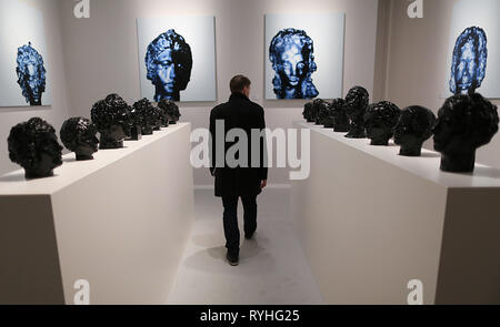 Maastricht, Netherlands. 13th Mar, 2019. A man walks between sculptures at the Andrea Caratsch Gallery stand at the TEFAF art fair. The fair will take place from 16 to 24 March 2019 and is considered the world's most important fair for ancient art. (to dpa 'Colonial debate catches up with art fair TEFAF' from 14.03.2019) Credit: Oliver Berg/dpa - ATTENTION: Only for editorial use in connection with the current reporting on the art fair TEFAF 2019/dpa/Alamy Live News Stock Photo
