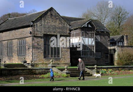 Bolton, Lancashire, UK. 14th Mar, 2019. A mix of sunshine and showers on a blustery day in Smithills Country Park, Bolton, Lancashire. The changeable weather is set to continue until the weekend in the North West of England. A family out for a stroll in the grounds of the historic Smithills Hall. Picture by Paul heres, Thursday March 14, 2019 Credit: Paul Heyes/Alamy Live News Stock Photo