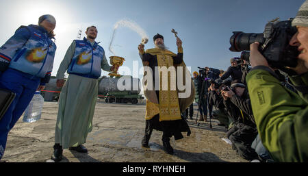 Baikonur, Kazakhstan. 14th Mar, 2019. Russian Orthodox Priest Father Sergei blesses the media and the Russian Soyuz MS-12 rocket on the launch pad as it prepares for liftoff at the Baikonur Cosmodrome March 14, 2019 in Baikonur, Kazakhstan. The Expedition 59 crew: Nick Hague and Christina Koch of NASA and Alexey Ovchinin of Roscosmos will launch March 14th for a six-and-a-half month mission on the International Space Station. Credit: Planetpix/Alamy Live News Stock Photo