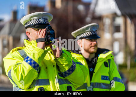 Edinburgh, Scotland, UK. 14 March, 2019. Police checking car speeds in Edinburgh at the first in a series of pilot 20mph ‘Roadside Education’ events, held in partnership with Police Scotland, aiming to raise awareness of the consequences of breaking 20mph speed limits. Speeding drivers will be stopped by Police Officers and offered a short driver education session in a Police Command Unit. Credit: Iain Masterton/Alamy Live News Stock Photo