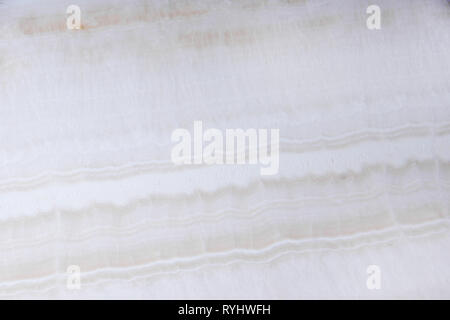 Natural white onyx stone with beautiful light waves. Stock Photo