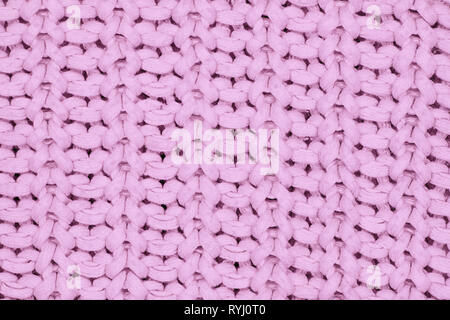 Real pink knit texture. Background, pattern concept. Knitted fabric made of heathered yarn Stock Photo