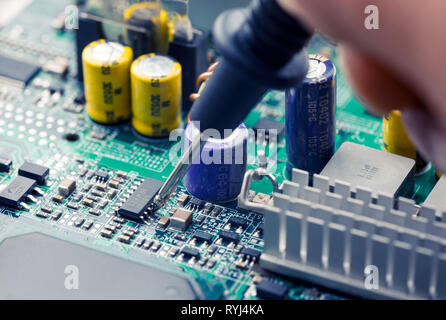 Close Up - Technician engineer measuring multimeter computer circuit board motherboard (Technology repairing computer Hardware) Stock Photo