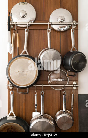 Hanging pots and pans on the wall. Stock Photo
