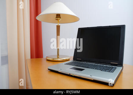 View of workplace in office. Laptop on desk. Stock Photo