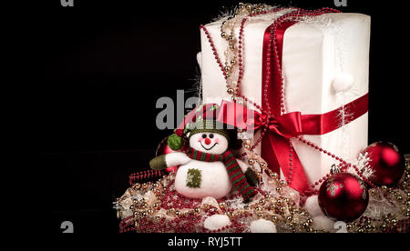box with Christmas present and Christmas decorations on a black Stock Photo