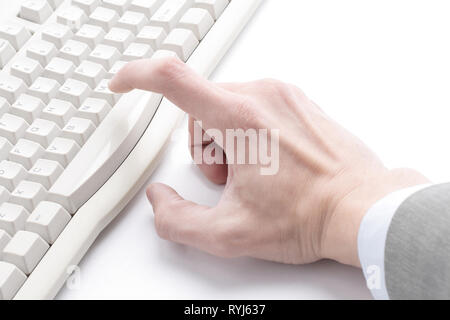 finger hit the button on the old computer keyboard Stock Photo