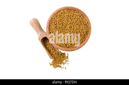 fenugreek seeds  in wooden bowl and scoop isolated on white background. top view. Spices and food ingredients. Stock Photo