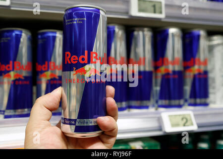 Stalls in row at supermarket. Soft drinks. Red Bull. Man shopping.   France. Stock Photo