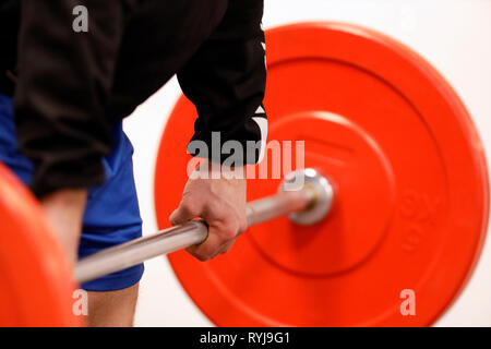 Man lifting weights in gym.  France. Stock Photo