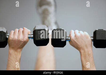Man lifting weights in gym.  France. Stock Photo