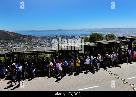 Tourist standing in a long line for the cable car that goes up to the top of the Table Mountain in Cape Town. Stock Photo